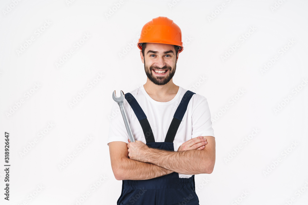 Happy young man builder in helmet posing isolated Happy young man builder in helmet posing isolated