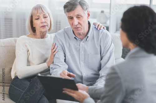 Senior couple talking to their financial advisor