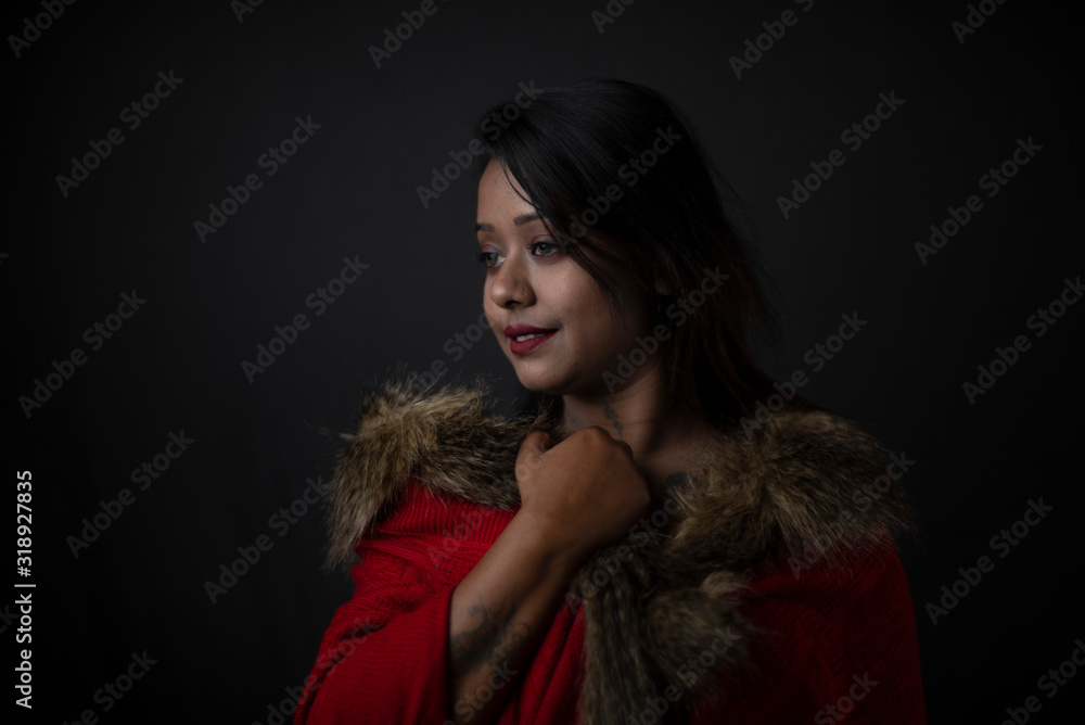 Fashion portrait of an young Indian Bengali brunette woman with black lingerie and furry shrug in black copy space background. Indian lifestyle and fashion photography. Fashion portrait of an young Indian Bengali brunette woman with black lingerie and furry shrug in black copy space background. Indian lifestyle and fashion photography.