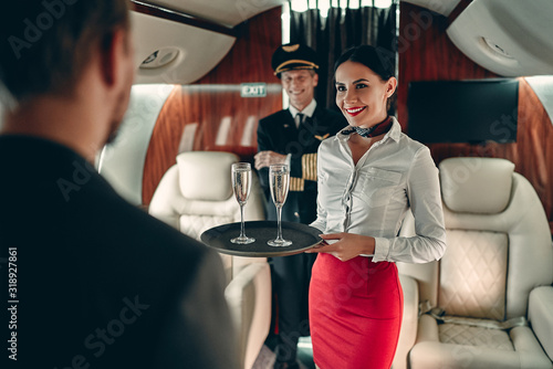 Fotografie Pilot and flight attendant in private jet