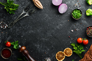 Black food background. Vegetables and spices on black background. Top view. Free space for your text.