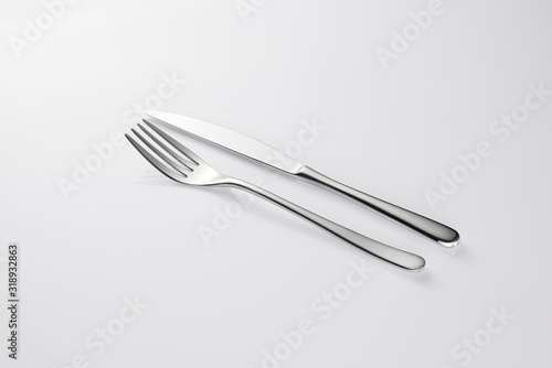 Fork and knife Stylish classy elegant metallic eating knife and fork cutlery for dining kitchen utensils Isolated on a white background, well lit. Kitchen set Flatware on white.