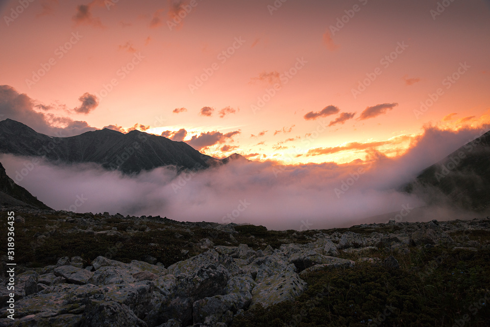 pink sunset sky over a mountain gorge with clouds background Stock ...
