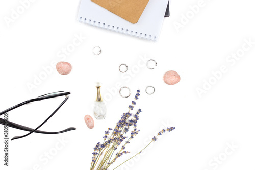 Workplace with glasses, rings, diary and lavender on a white background. Flat lay, top view