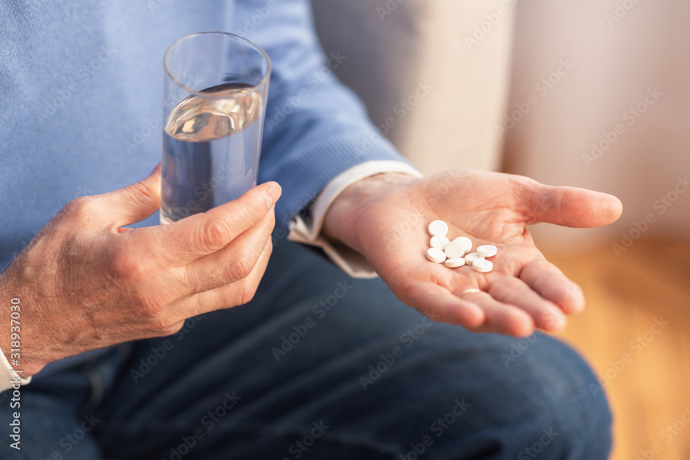 Unrecognizable Gentleman Holding Pills Sitting On Sofa At Home, Cropped Unrecognizable Gentleman Holding Pills Sitting On Sofa At Home, Cropped