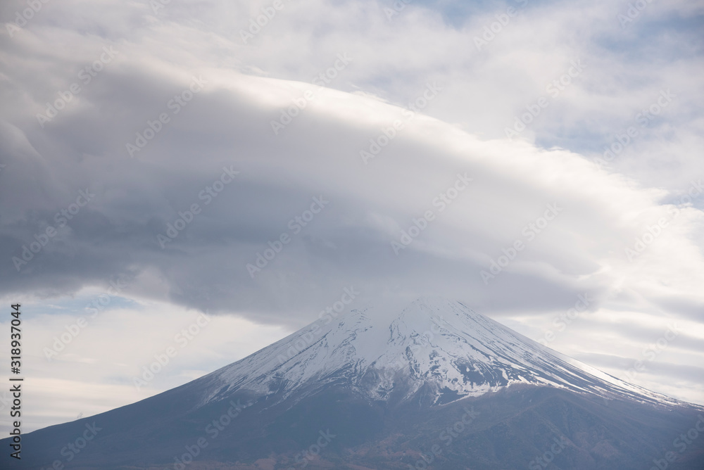 Snowcapped and cloud hat phenomena against the most beautiful volcano of the world Mt. Fuji.