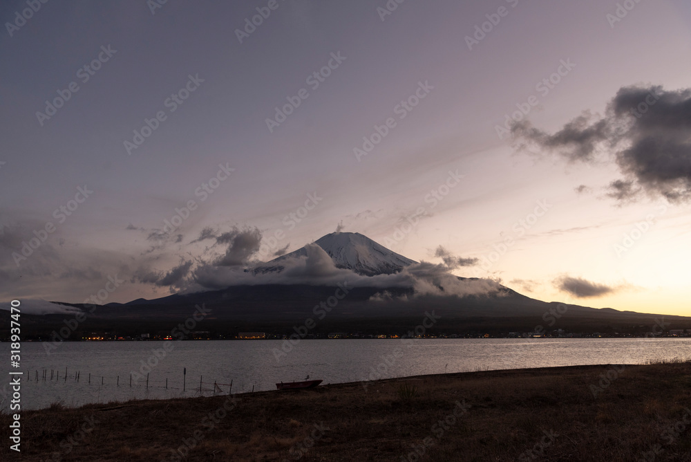 Symmetry snowcapped volcano mountain Fuji against Yamanakako famous tourist lake.