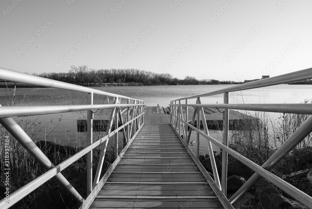 Walkway ramp to lake boat dock. Steel ramp walkway leading to boat