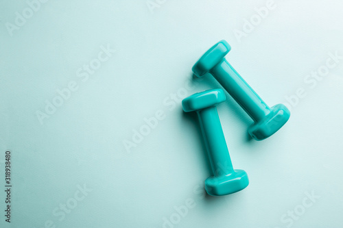 Blue dumbbells isolated on blue background, top view