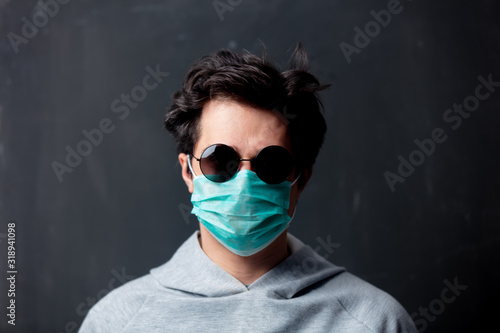 young white man in protective mask and sunglasses