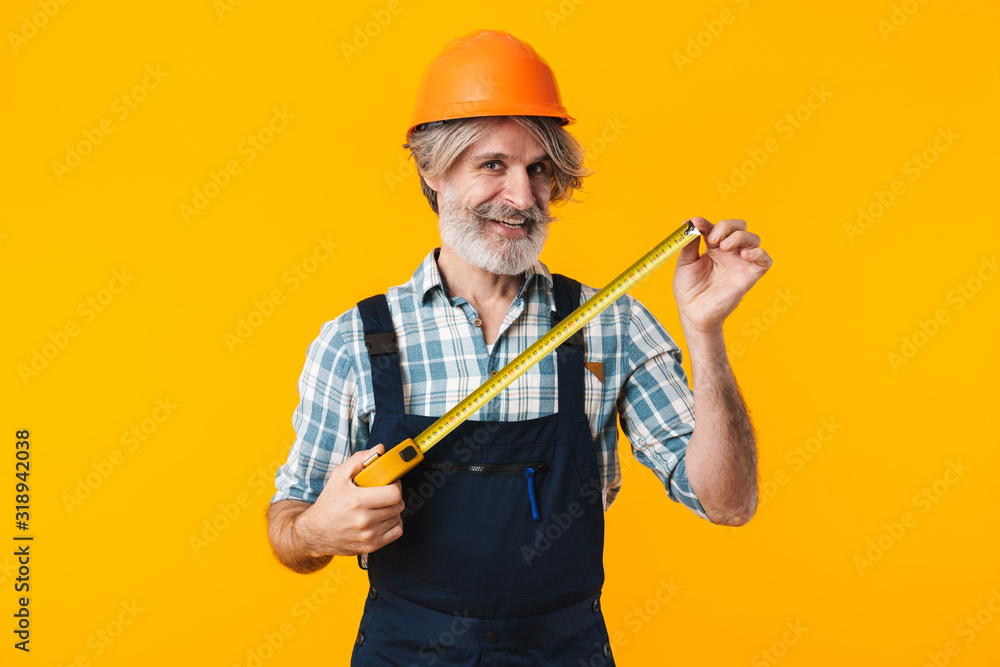 Bearded man holding centimeter. Bearded man holding centimeter.
