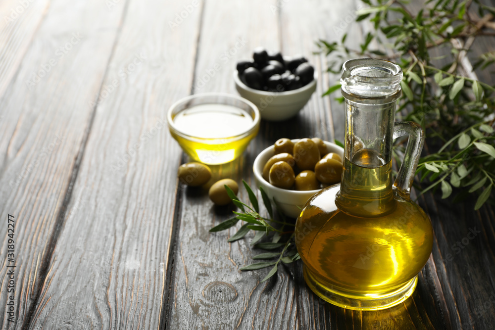 Composition with olive oil and olives on wooden background, close up Composition with olive oil and olives on wooden background, close up