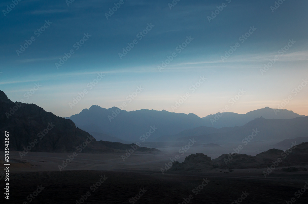desert with rocky mountains and sky with clouds in the evening in Egypt