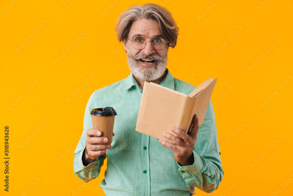 Happy bearded man reading book drinking coffee. Happy bearded man reading book drinking coffee.