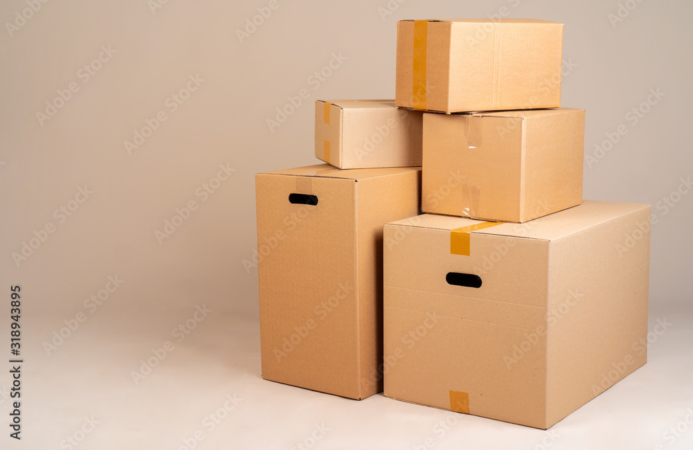 Pile of brown moxing boxes on grey background