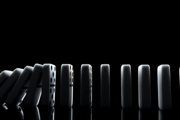 White dominoes in the dark close up