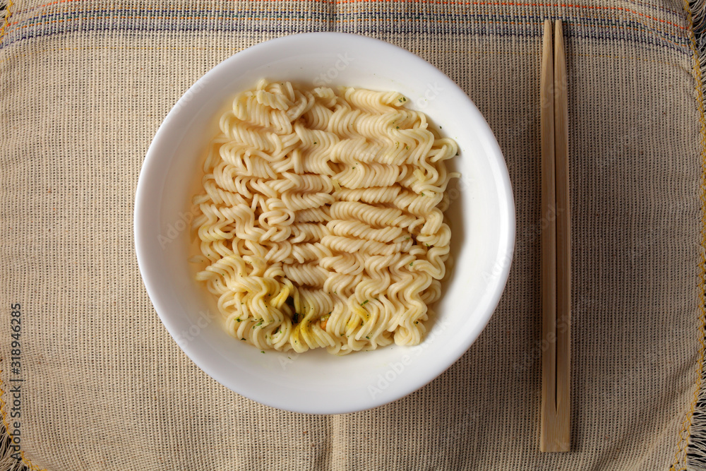 brewed noodles on a light burlap background brewed noodles on a light burlap background