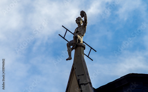 April 26, 2018 Riga, Latvia. A chimney sweep sculpture on the roof of a house in Riga.