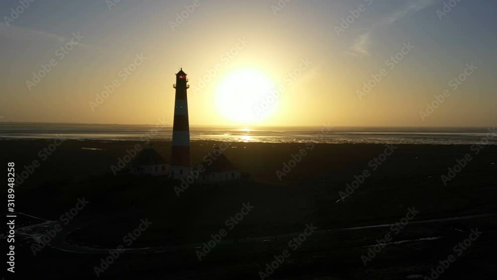 Lighthouse at sunset, aerial view, silhouette Lighthouse at sunset, aerial view, silhouette