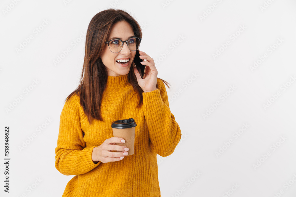 Image of adult woman holding coffee cup and talking on cellphone Image of adult woman holding coffee cup and talking on cellphone