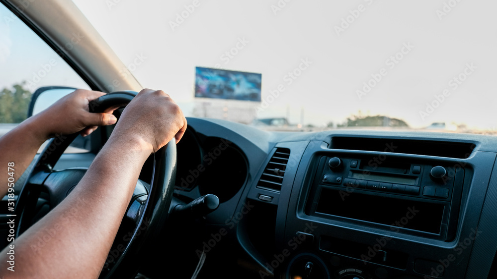 Photo of the hand is controlling the steering wheel