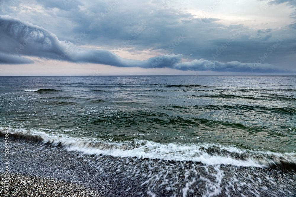 Stormy weather at sea and fantastic clouds. The approaching shower in rainy weather over the sea. Stormy weather at sea and fantastic clouds. The approaching shower in rainy weather over the sea.