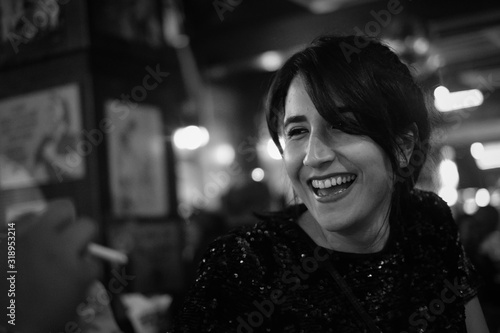 Black and white candid portrait of smiling beautiful young iranian persian girl