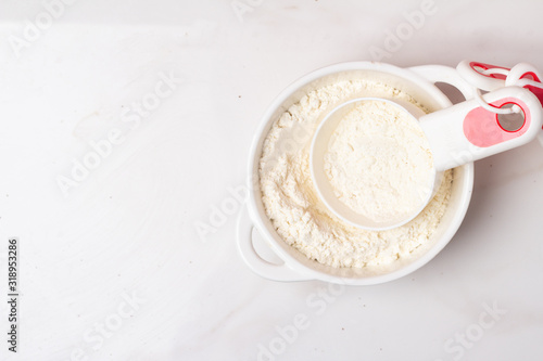 cup with flour on a white background