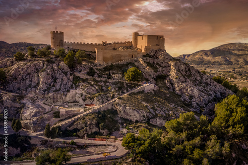 HIlltop Castalla castle near Alicante Spain with donjon and battered wall surrounding a courtyard