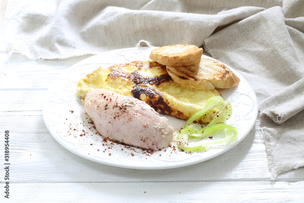 Baked chicken breast with spices and scrambled eggs with croutons Baked chicken breast with spices and scrambled eggs with croutons