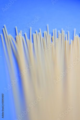 raw spaghetti on blue background