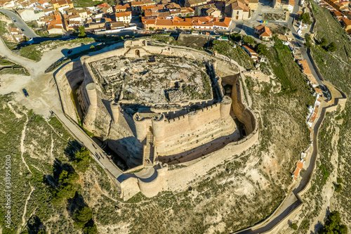 Aerial view of Chinchilla de Montearagon castle with ruined excavated inner building remains surrounded by an outer wall with semi circular towers