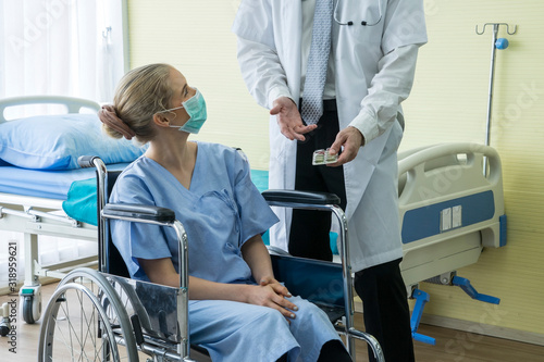 The doctor checked the patient's fever and explain treatment the sick patient to lie on the hospital bed.Medical healthcare concept.