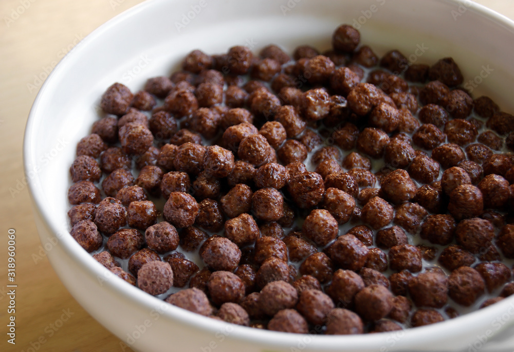 White plate with chocolate cereal for breakfast. White plate with chocolate cereal for breakfast.