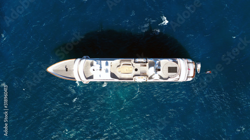 Aerial drone photo of luxury mega yacht docked in Mediterranean destination with deep blue wavy sea © aerial-drone