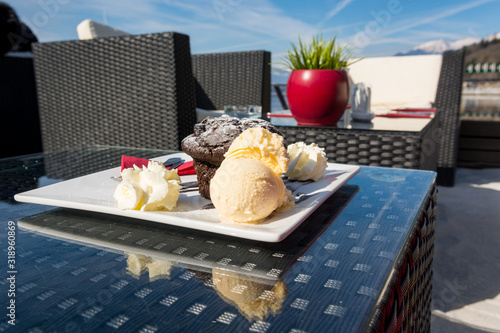 Delicious chocolate muffin served with vanilla ice cream. photo
