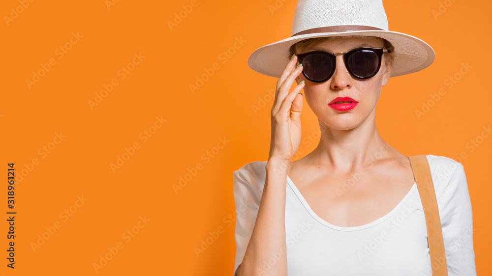 Beautiful womanin white clothes wearing black sunglasses, minimal style, spring and summer fashion concept Beautiful womanin white clothes wearing black sunglasses, minimal style, spring and summer fashion concept