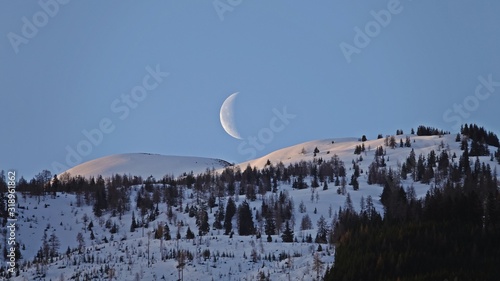 beautiful morning sky with moon, blue clear sky and mountains