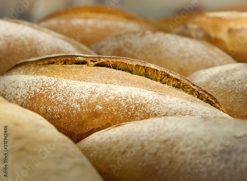 Loafs of French sourdough or French baguette, Freshly baked traditional french bread. Selective focus and close up. photo