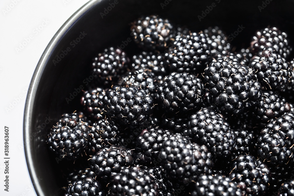 Blackberries in a black bowl, ripe fresh berries macro photo Blackberries in a black bowl, ripe fresh berries macro photo