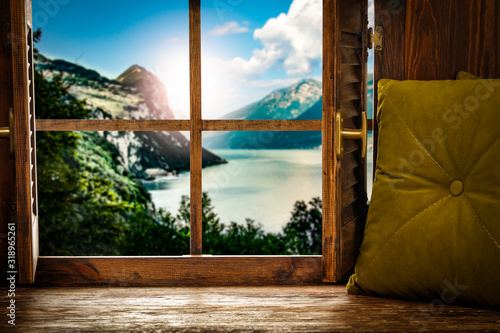 Wooden window sill background with pillows and free space for your decoration.Landscape of spring lake with mountains nad copy space 