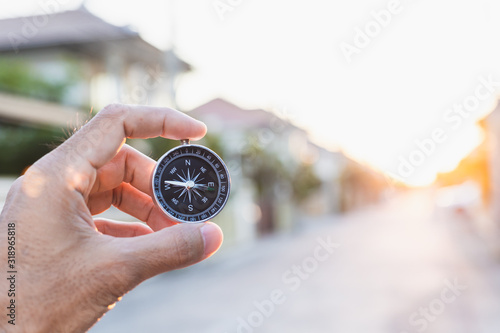 man holding compass on blurred background. for activity lifestyle outdoors freedom or travel tourism and inspiration backpacker alone tourist travel or navigator image.