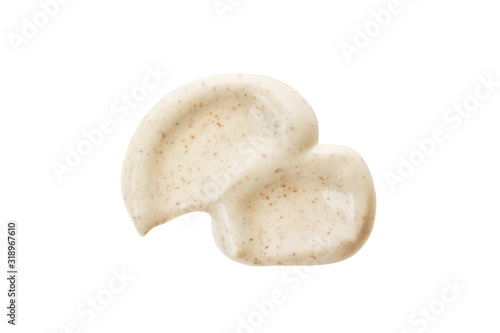 фотографія White face scrub mask smear with dark particles isolated on white