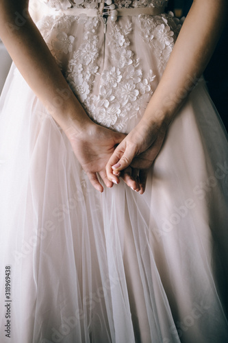 The bride's hands her back © olegzaicev