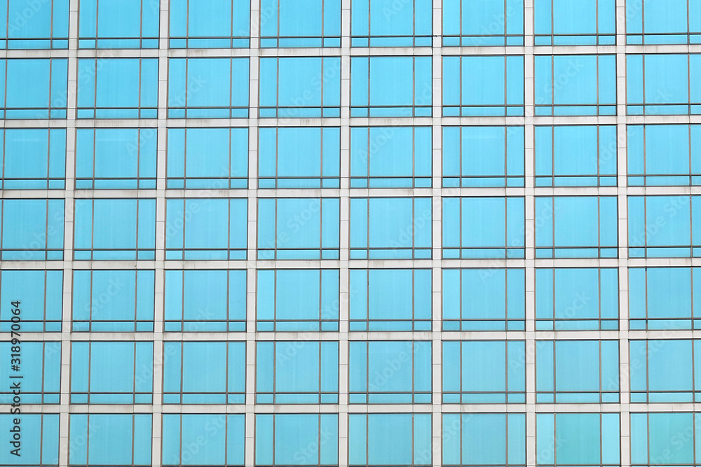 Modern office building with many windows on glass wall. Modern office building with many windows on glass wall.