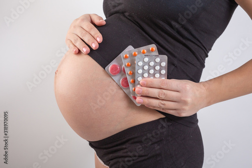 pregnancy, people and health care concept - close up of pregnant woman. vitamins and minerals for pregnant women. Taking medications during pregnancy. Colds and pregnancy. Medicines for pregnant women