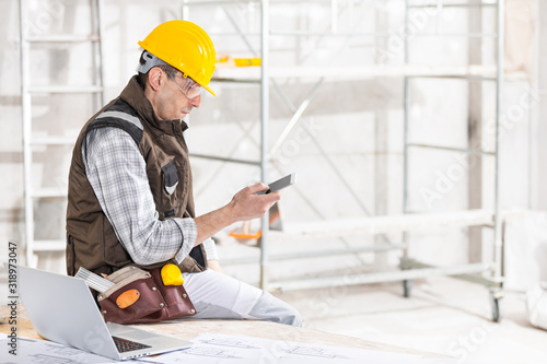 Builder or contractor using a mobile phone on site