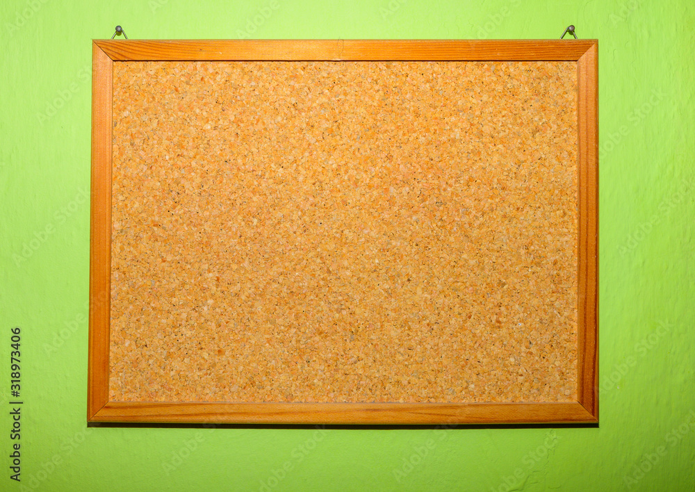 Fototapeta premium Blank Cork board with wooden frame on green background prepared for your reminder