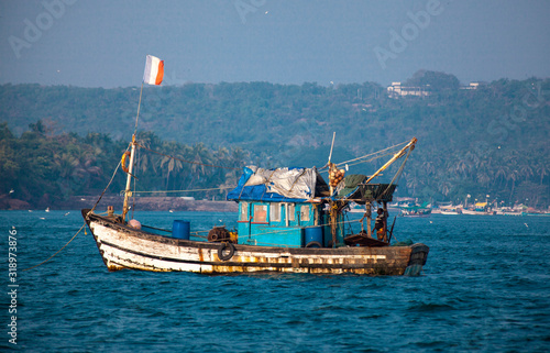 An old Indian fishing boat. The ship sails on the sea in search of fish.