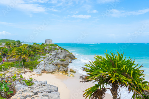Ruins of ancient Tulum. Architecture of ancient maya. View with sea. Blue sky and lush greenery of nature. travel photo. Wallpaper or background. Yucatan. Mexico.